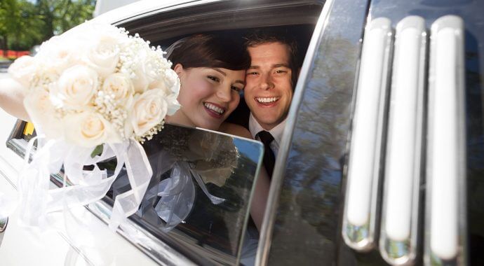 couple enjoying a wedding limo rental